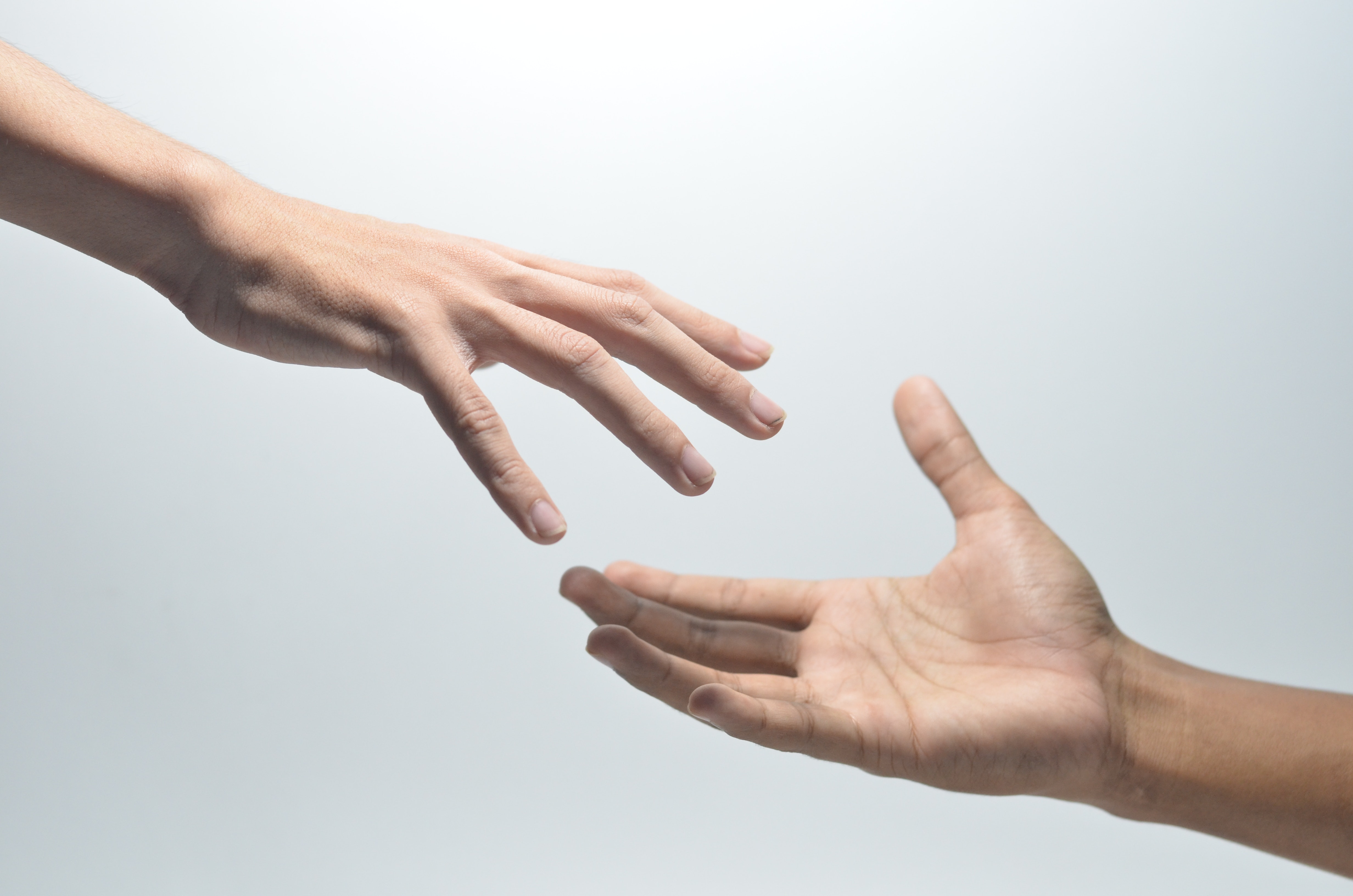 Two hands reaching out to each other.